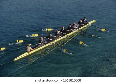 Team of rowers in business suits
