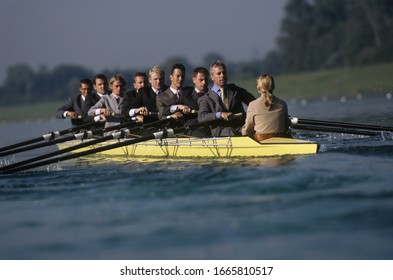 Team Of Rowers In Business Suits