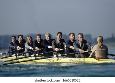 Team Of Rowers In Business Suits