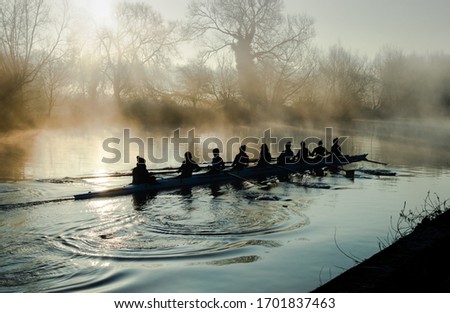 Team rowing on a mirror