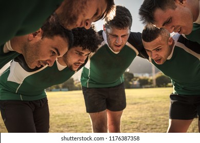 Team Of Rugby Players In Huddle Discussing Their Tactics. Professional Rugby Team In Huddle During The Game.