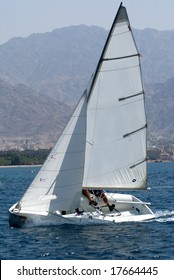 Team Sailing On A Small Sail Boat