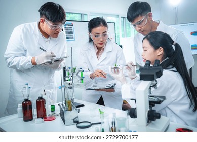 Team of scientists collaborating on algae and plant-based bioenergy research in laboratory, representing renewable energy testing clean technology innovation, sustainability, and ESG-focused corporate
