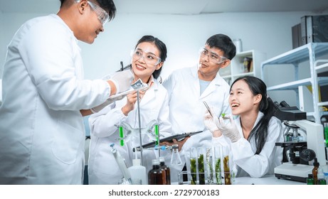 Team of scientists collaborating on algae and plant-based bioenergy research in laboratory, representing renewable energy testing clean technology innovation, sustainability, and ESG-focused corporate