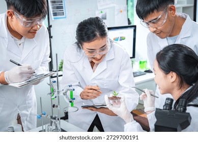 Team of scientists collaborating on algae and plant-based bioenergy research in laboratory, representing renewable energy testing clean technology innovation, sustainability, and ESG-focused corporate
