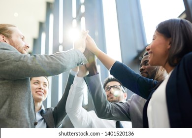 Team Of Several Successful Intercultural Delegates Giving High Five As Symbol Of Partnership And Support