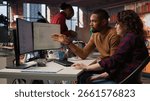 Team of IT specialists using programming languages on PC in startup office to build applications. Teamworking colleagues using computer in software development agency to code, camera A