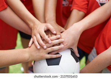 Team Spirit. Cropped Image Of A Group Of Girls With Their Hands Piled On Top Of A Soccer Ball.