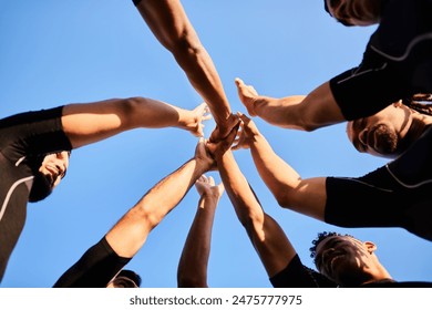 Team spirit. Cropped shot of a handsome group of sportsmen huddled together with their hands in the middle before playing rugby. - Powered by Shutterstock