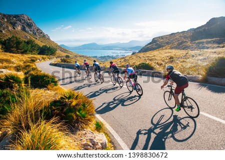 Team sport cyclist photo. Group of triathlete on bicycle ride on the road at Mallorca, Majorca, Spain.