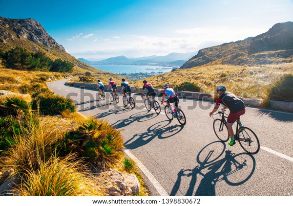 Team sport cyclist\
photo. Group of triathlete on bicycle ride on the road at Mallorca,\
Majorca, Spain.