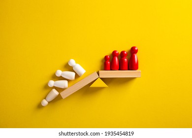 Team standing on a wooden seesaw, one side winner and one side loser. Success and failure. Business and workplace competition. - Shutterstock ID 1935454819