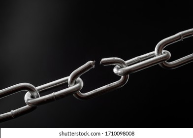 The team is as strong as its weakest link and single point of failure concept with powerful iron chain with one stressed link breaking under physical pressure isolated on black background