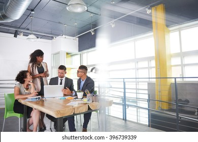 Team Of Successful Business People Having A Meeting In Executive Sunlit Office