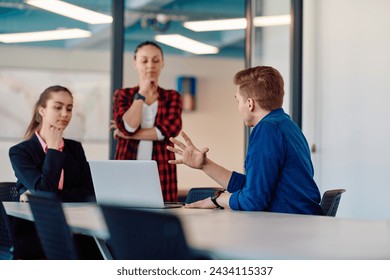 A team of successful programmers sits in a startup office, strategizing new business projects and solving existing challenges, showcasing innovation and collaboration in the tech industry