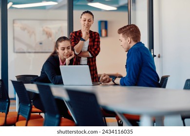 A team of successful programmers sits in a startup office, strategizing new business projects and solving existing challenges, showcasing innovation and collaboration in the tech industry
