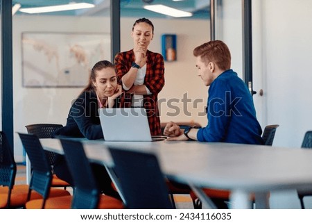 A team of successful programmers sits in a startup office, strategizing new business projects and solving existing challenges, showcasing innovation and collaboration in the tech industry