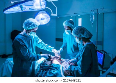 Team of surgeon doctor using defibrillator to give electrical shock wave to patient heart who is suffering from cardiac arrest in emergency surgical room for healthcare concept - Powered by Shutterstock