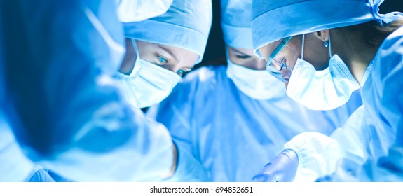 Team surgeon at work on operating in hospital - Shutterstock ID 694852651