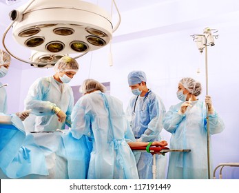 Team surgeon at work in operating room.