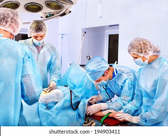 Team surgeon at work in operating room.