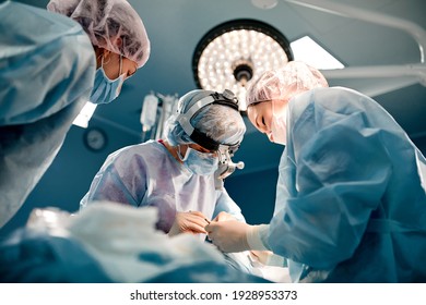 A team of surgeons is fighting for life, for a real operation, for real emotions. The intensive care team is fighting for the life of the patient. Saving life, the struggle for life - Shutterstock ID 1928953373