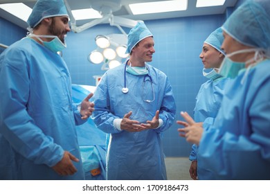 Team of surgeons having discussion in operation theater at hospital. Healthcare workers in the Coronavirus Covid19 pandemic
 - Powered by Shutterstock