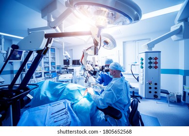 A Team Of Surgeons Performing Brain Surgery To Remove A Tumor.