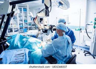 A team of surgeons performing brain surgery to remove a tumor. - Shutterstock ID 1831368337