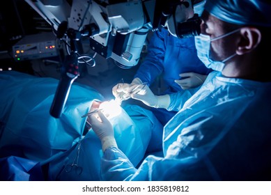 A Team Of Surgeons Performing Brain Surgery To Remove A Tumor.