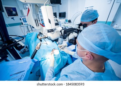 A team of surgeons performing brain surgery to remove a tumor. - Shutterstock ID 1845083593