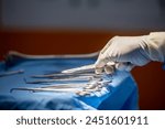 Team of surgery doctor in Operating Room hold hands scalpel surgical blade give to Surgeons During Operation. surgeons assistance in green gown coat give scalpel surgical blade to doctor