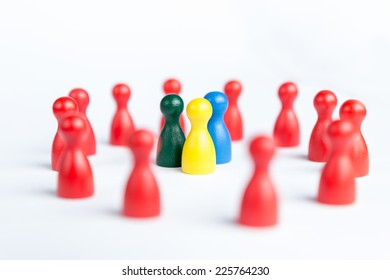 Team surrounded by adversity or praised for being different concept with figurines - Shutterstock ID 225764230