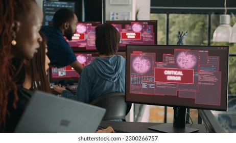 Team of system engineers having web server hacked, reading critical error on multiple monitors in office. Diverse software developers trying to solve hacking problem, firewall security.
