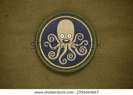 The team Tako USN G11 morale patch is velcro for attaching to clothes and bags.