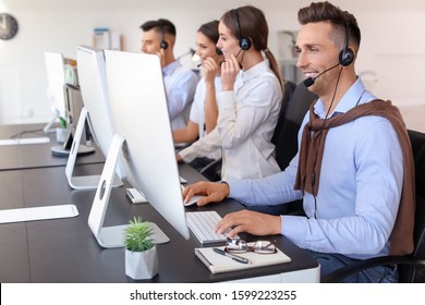 Team Of Technical Support Agents Working In Office