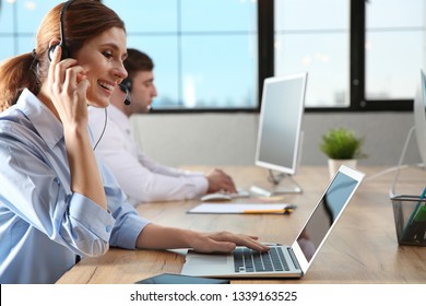 Team of technical support with headsets at workplace