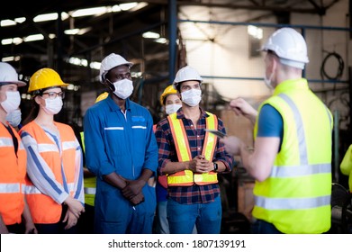 A team of technicians, foreman and engineers Accepting assignments from a manager or team leader In the morning meeting before work In which everyone wear surgical masks to prevent the coronavirus - Shutterstock ID 1807139191