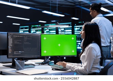 Team of technicians using green screen laptop to do maintenance on high bandwidth, dedicated game servers used to accommodate incoming traffic of online users joining from worldwide locations