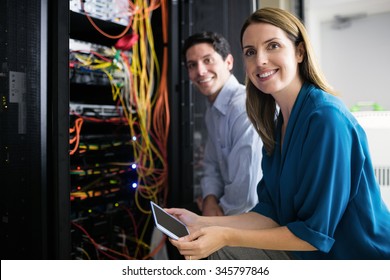 Team of technicians working together on servers at the data centre