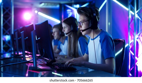 Team of Teenage Gamers Play in Multiplayer PC Video Game on a eSport Tournament. Captain Gives Commands into Microphone, Trying Strategically Win the Game.