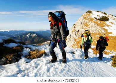 Team Of Three Alpinists Climbing A Mountain