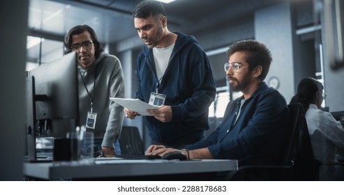 Team of Three Multiethnic Diverse Software Developers Talk, Discuss and Collaborate on an AI Project. Empowered Young Indian Specialists Work on Digital E-Commerce Startup Business