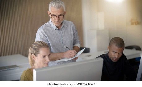 Team Of Three People Working On A Training
