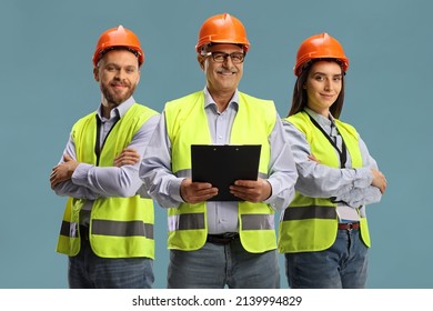 Team of three site engineers isolated on blue background - Powered by Shutterstock