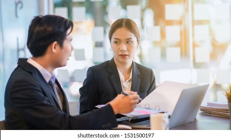 Team of two business people working together in workplace using laptop computer - Shutterstock ID 1531500197