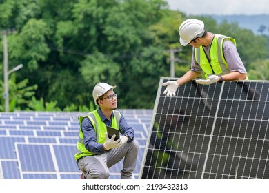 A team of two engineers are working to install solar panels at a solar power station. Engineer team discussing the work to install solar cells - Shutterstock ID 2193432313