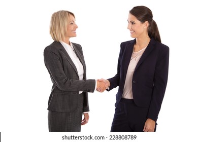 Team: Two isolated businesswoman shaking hands wearing business outfit 