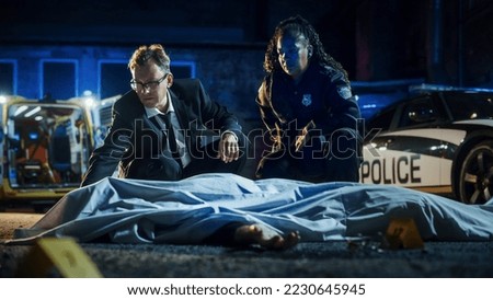 Team of Two Multiethnic Police Officers Working on Profiling a Killer on the Loose.Male Detective and a Policewoman Considering Clues and Evidence to Solve a Complicated Murder Case. Teamwork Concept