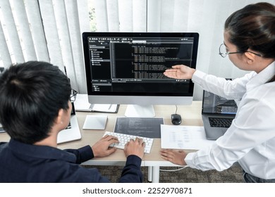 Team of two professional programmers working on website projects in software development and making coding and typing data code password security in office.